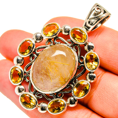 Sterling silver citrine and rutilated quartz pendant with oval center and bezel surround