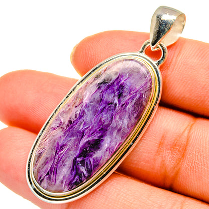 Oval charoite pendant in sterling silver bezel, vivid purple crystal texture.