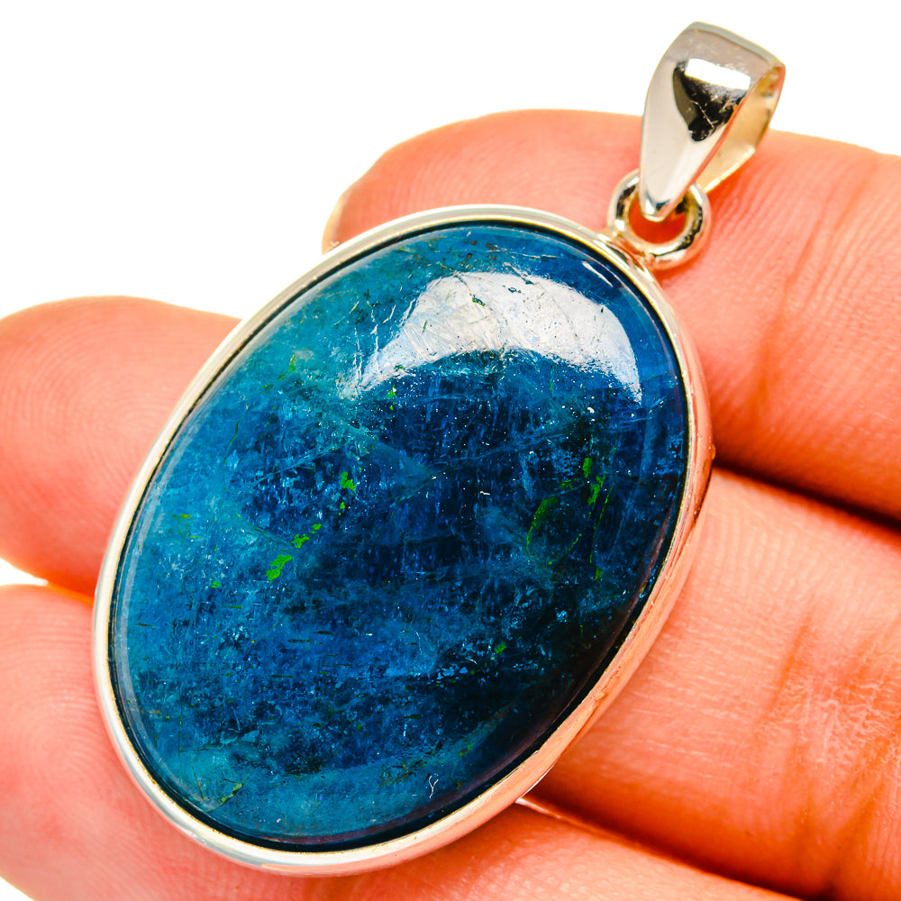 Oval apatite gemstone pendant in silver bezel with blue stone and bail
