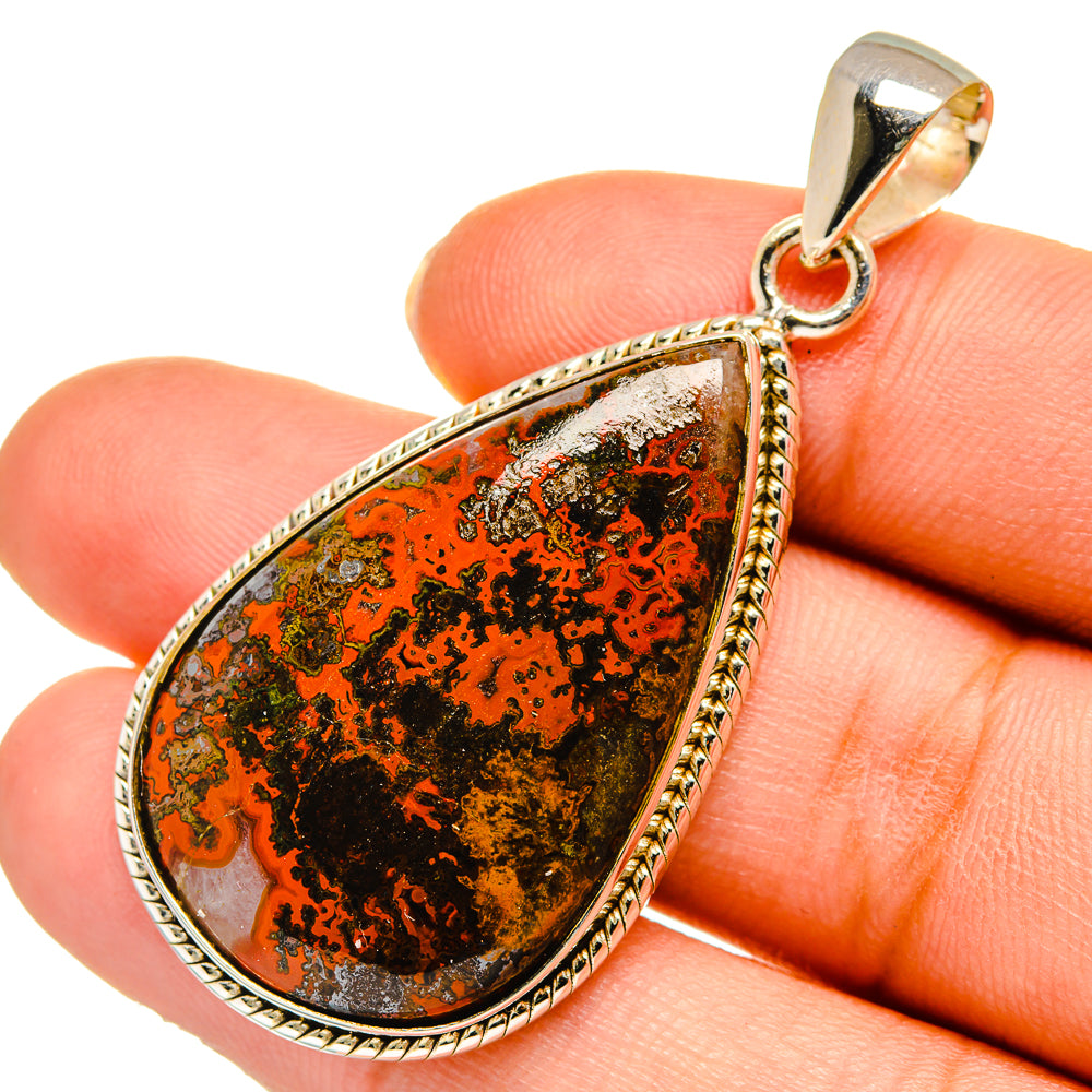Teardrop agate pendant with orange and dark pattern, framed in polished sterling silver