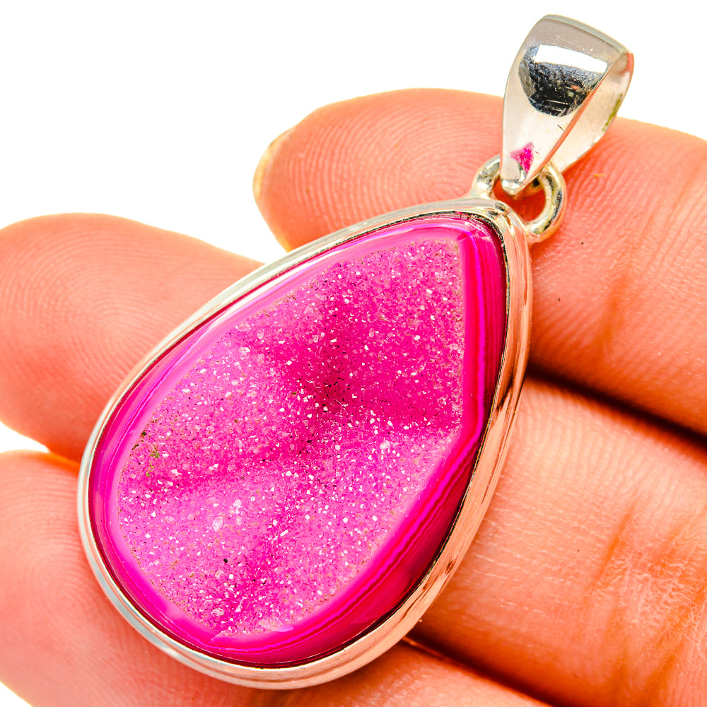Teardrop druzy agate pendant in bright pink with gold bail on finger