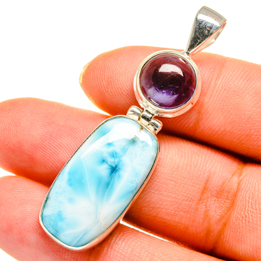 Sterling silver pendant with oval blue larimar and round purple stone, bail top