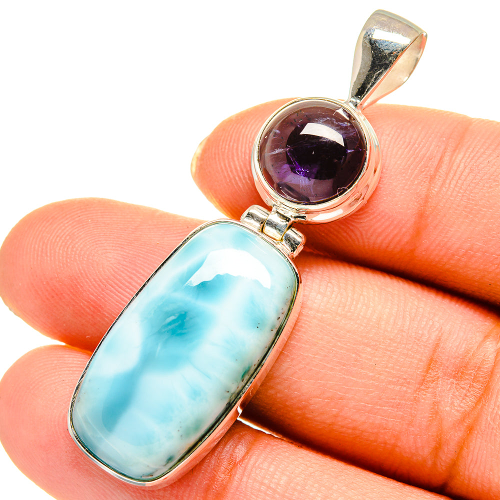 Sterling silver pendant close-up with blue larimar oval and purple tanzanite cabochon