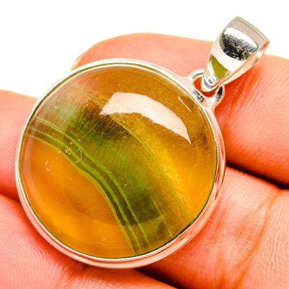 Green fluorite pendant with round amber-green cabochon, silver bezel and bail