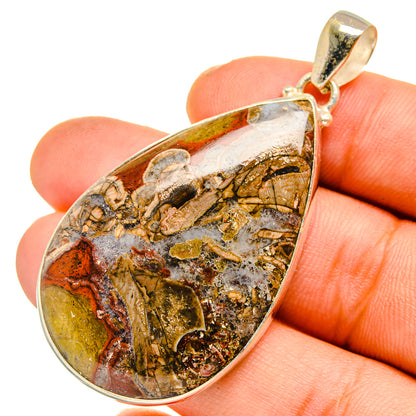 Teardrop rhyolite pendant with gold-toned bail and marbled mushroom-pattern stone