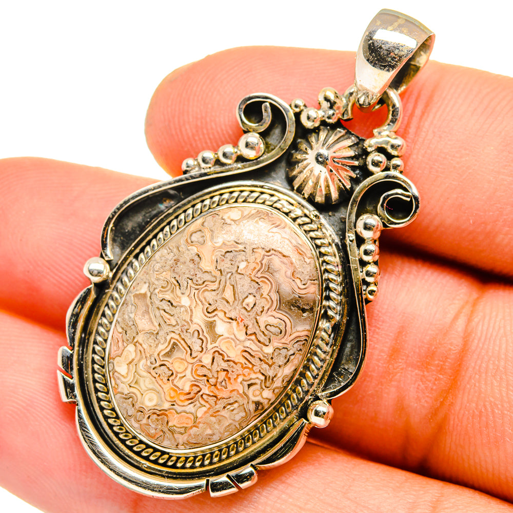 Sterling silver lace agate pendant with oval cabochon and ornate scalloped bezel