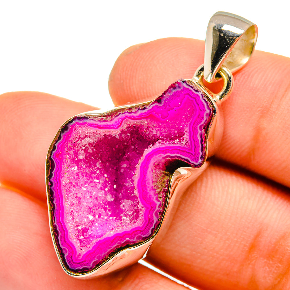 Pink geode slice pendant close-up, faceted crystal inside silver bezel and bail.