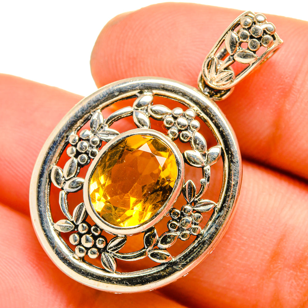Round sterling silver pendant with faceted yellow citrine and ornate bezel setting