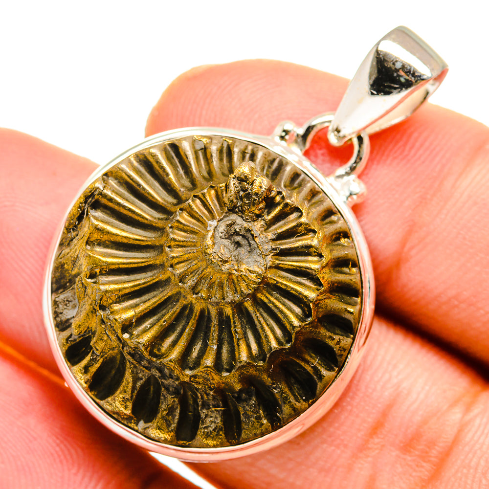 Close-up pyrite fossil pendant: gold sunburst pattern in silver bezel with loop bail