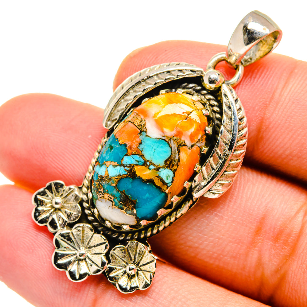 Spiny oyster turquoise pendant close-up, oval stone with orange highlights and teal veins