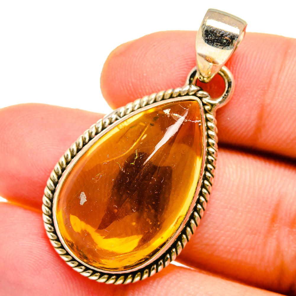 Sterling silver citrine teardrop pendant with rope bezel and gold-tone bail