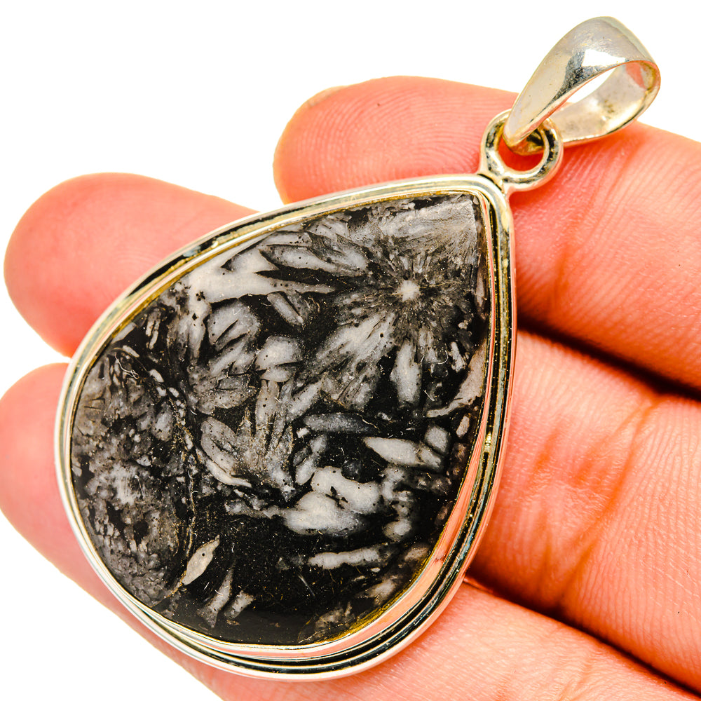 Teardrop sterling silver pendant with black stone and white flower-like veining