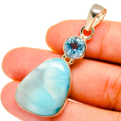Sterling silver pendant with round blue topaz and pear-shaped larimar cabochon