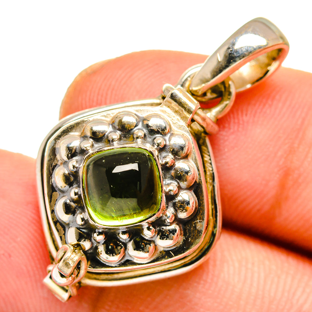 Sterling silver pendant with faceted green square center stone and loop clasp