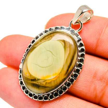 Sterling silver jasper pendant with oval yellow-brown cabochon and dark bead border