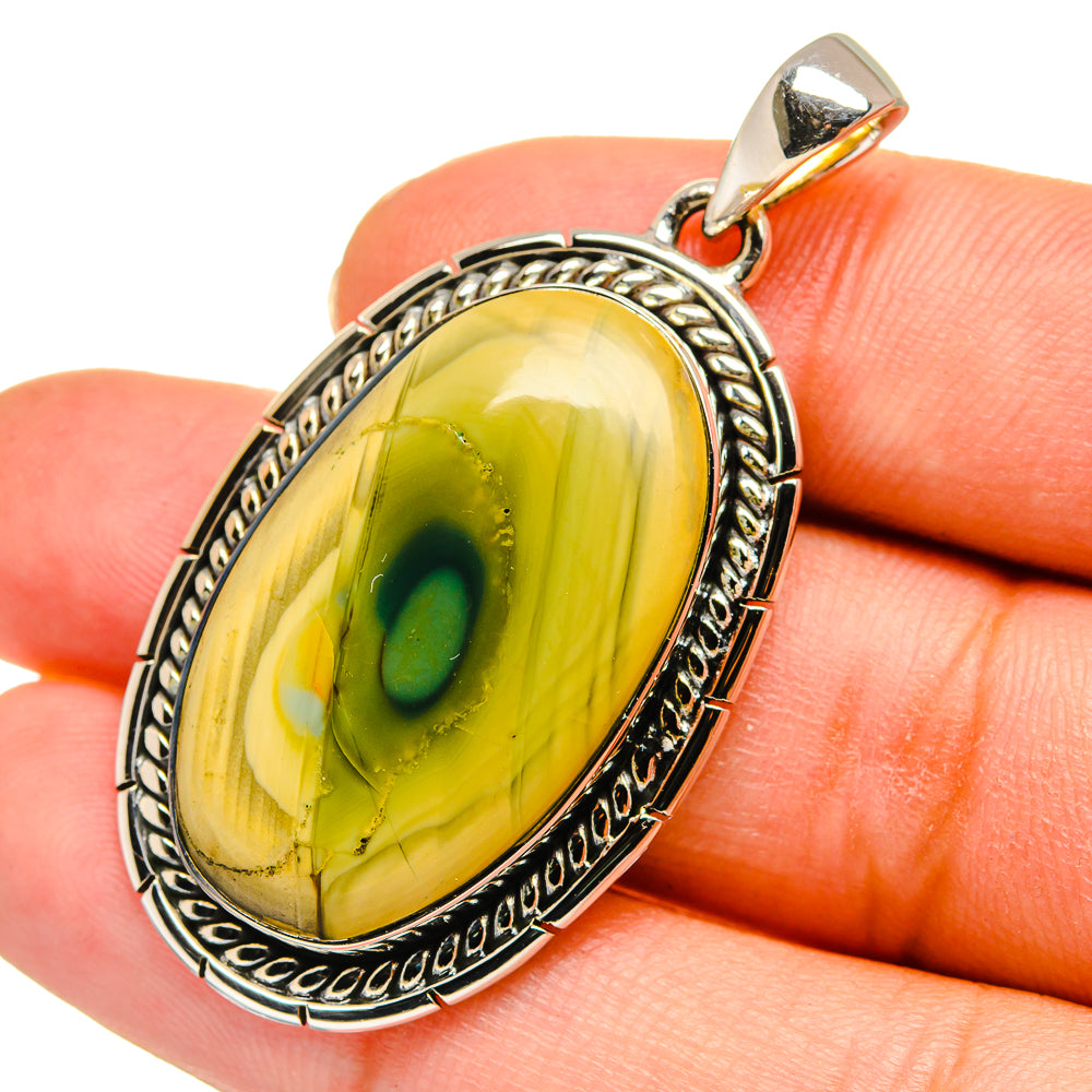 Oval jasper pendant on bail, yellow-green cabochon in engraved silver bezel
