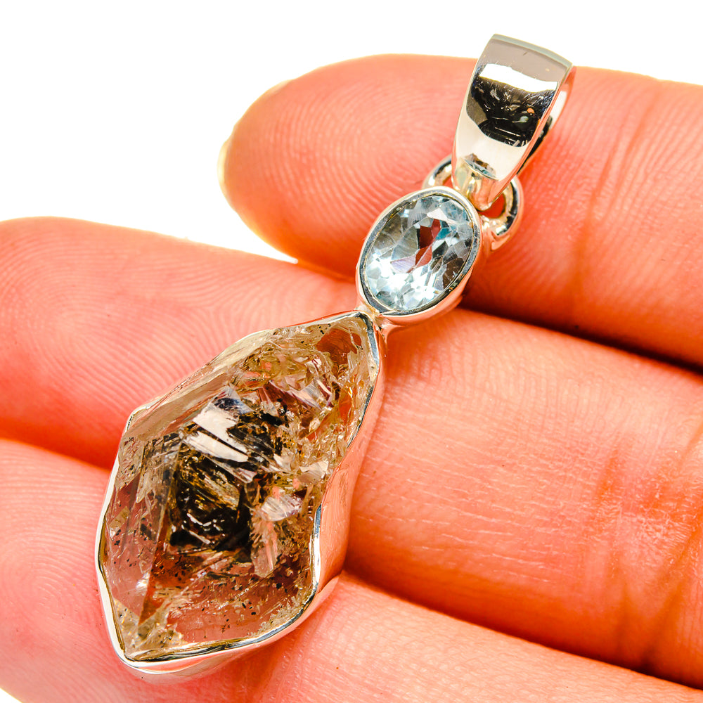 Sterling silver pendant with raw herkimer diamond and oval blue topaz bezel