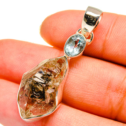 Sterling silver pendant with raw herkimer diamond and oval blue topaz bezel
