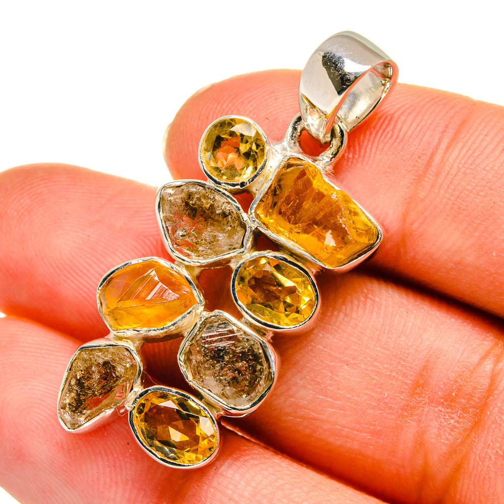 Sterling silver pendant with rough and faceted yellow citrine stones, close-up detail