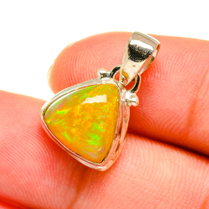 Orange opal heart pendant with green flashes, sterling silver frame and bail