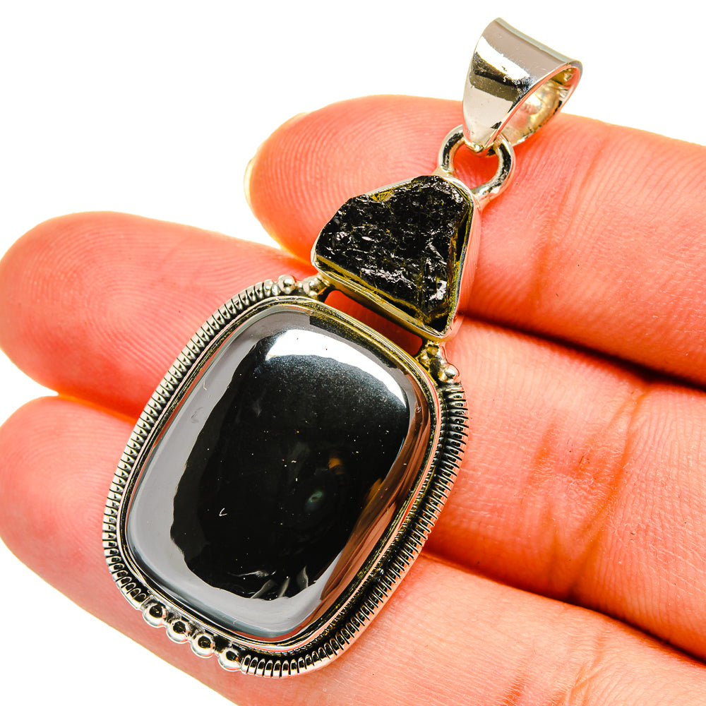 Black gemstone pendant on silver bail, oval bezel with textured center and bead border
