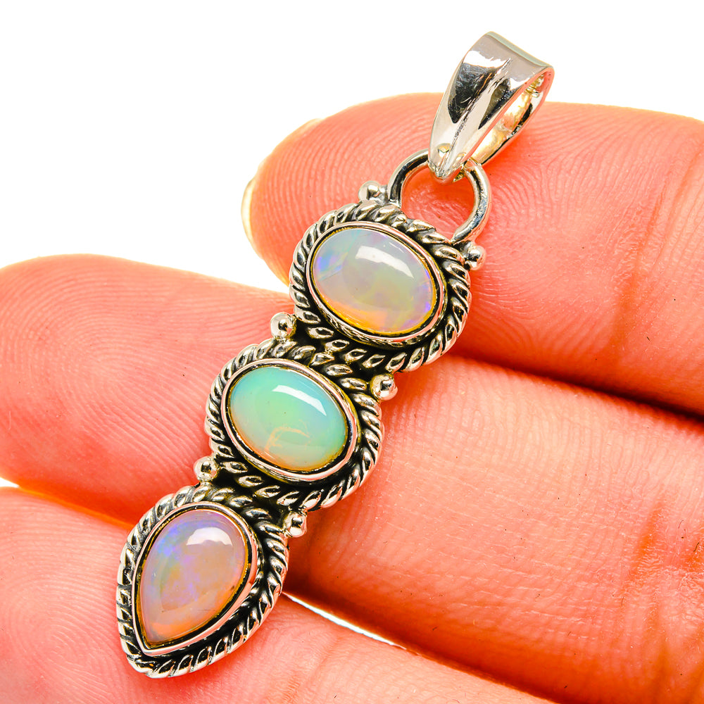 Sterling silver opal pendant with three multicolor teardrop cabochons, top bail