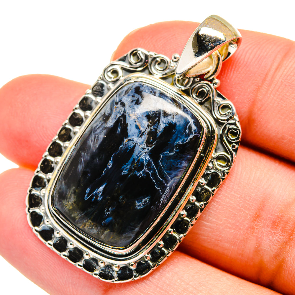 Sterling silver pietersite pendant with blue rectangular stone and ornate bezel, bail top