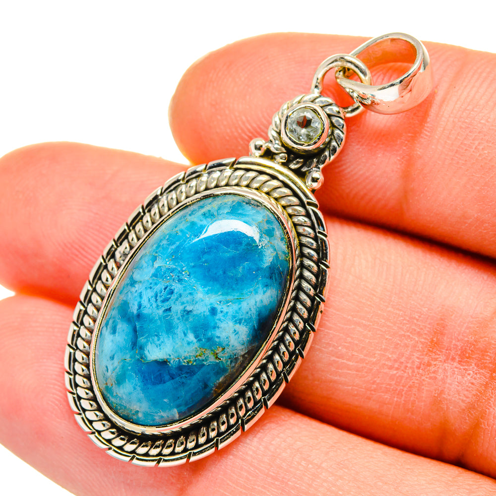 Blue oval gemstone pendant with ornate 925 sterling silver frame and small round accents