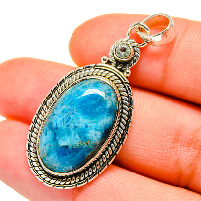 Blue oval gemstone pendant with ornate 925 sterling silver frame and small round accents