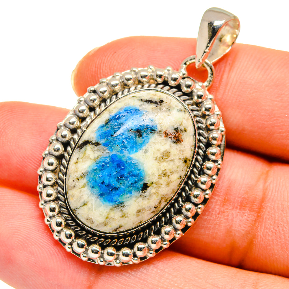 Sterling silver azurite pendant with oval blue cabochon and textured halo bezel