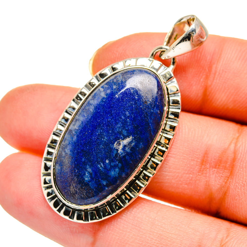 Sodalite pendant close-up with sterling silver border and oval blue stone in bezel