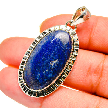Sodalite pendant close-up with sterling silver border and oval blue stone in bezel