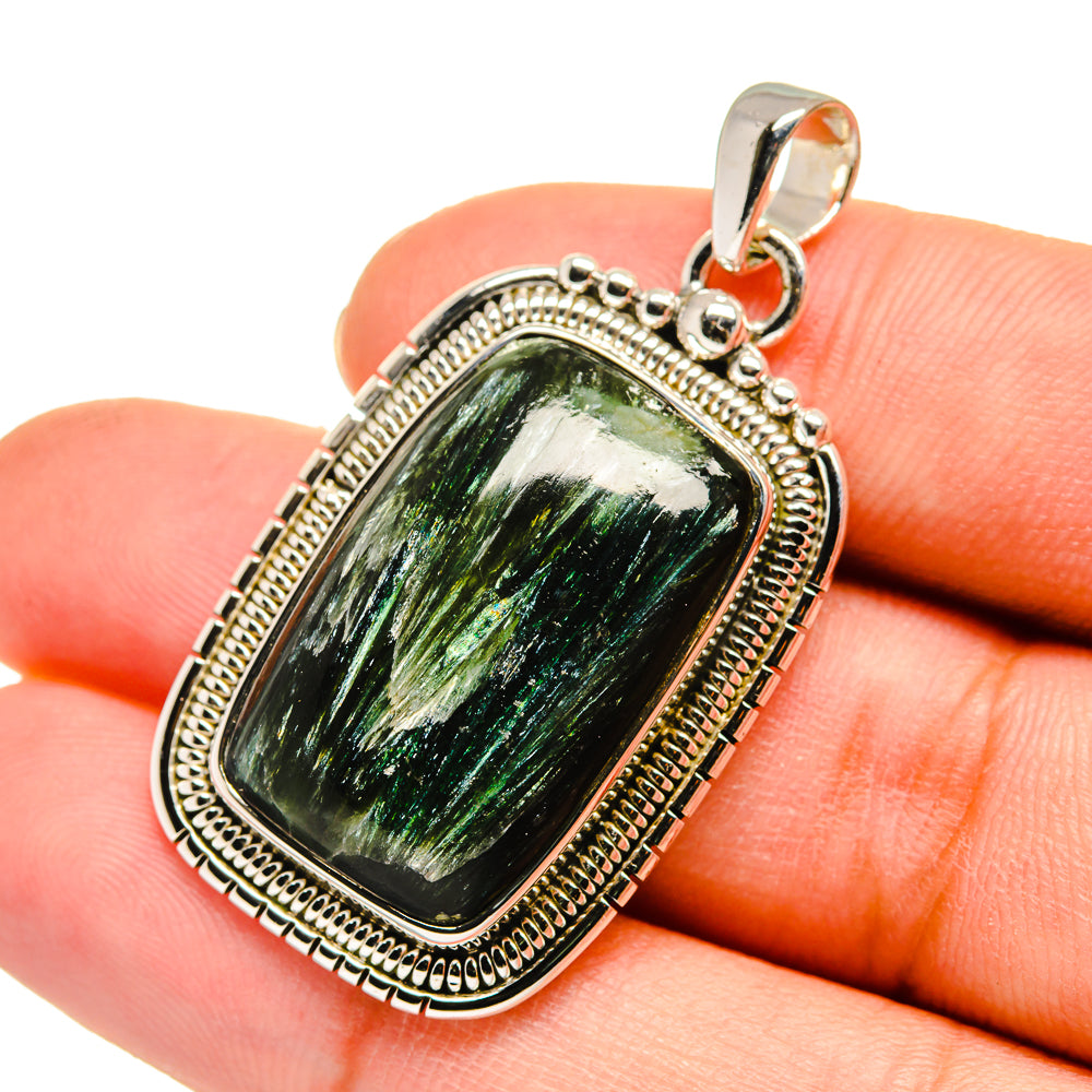 Sterling silver pendant with green rectangular gemstone close-up and ornate beaded frame