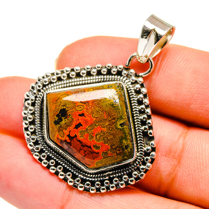 Sterling silver pendant with orange-red and black marbled agate stone, on-hand scale