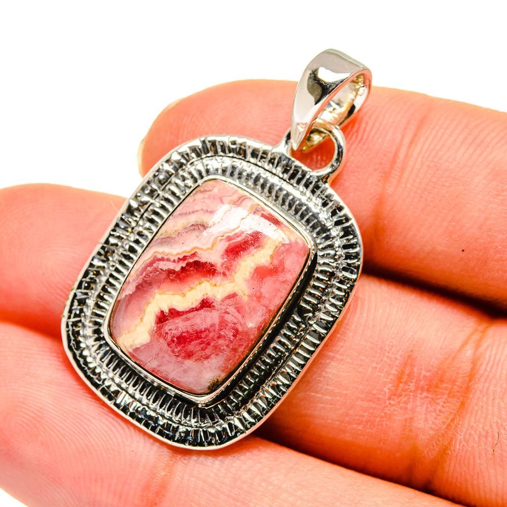 Sterling silver rhodochrosite pendant with pink red marbled stone, oval bezel and bail.