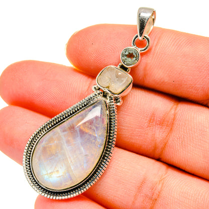 Moonstone pendant with teardrop iridescent stone, silver bezel, and round stone accents