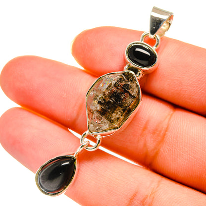 Sterling silver pendant with teardrop black onyx and center herkimer-style crystal setting