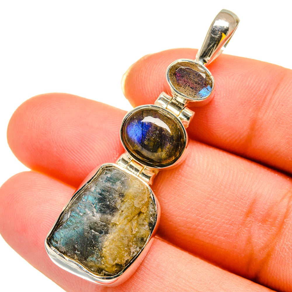 Rough labradorite pendant close-up, round stone shows blue flash in sterling silver bezel
