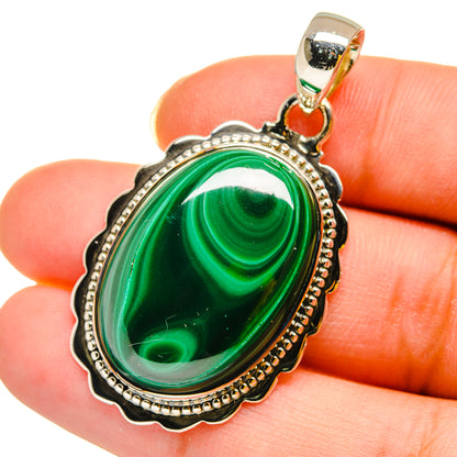 Malachite oval pendant in silver-tone bezel with loop bail