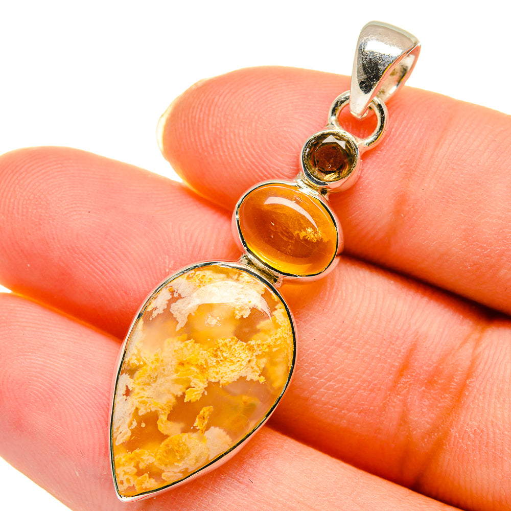 Teardrop yellow gemstone pendant on sterling silver bail, close-up on cabochon details