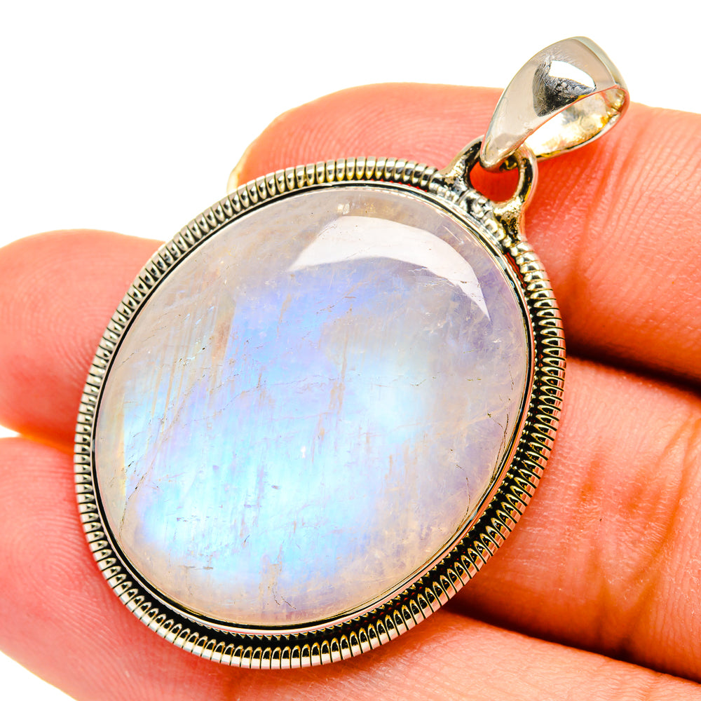 Oval rainbow moonstone pendant in sterling silver bezel with bail