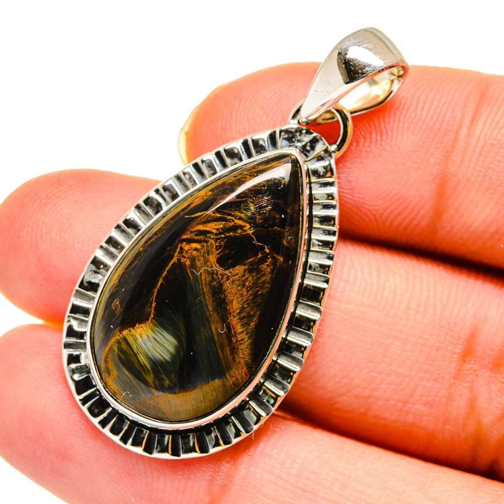 Pietersite pendant on finger scale, 925 sterling silver teardrop with black-gold striped stone