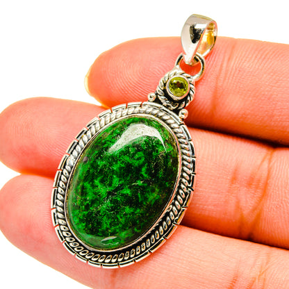 Oval green peridot pendant with textured silver bezel and loop bail, 925 sterling silver