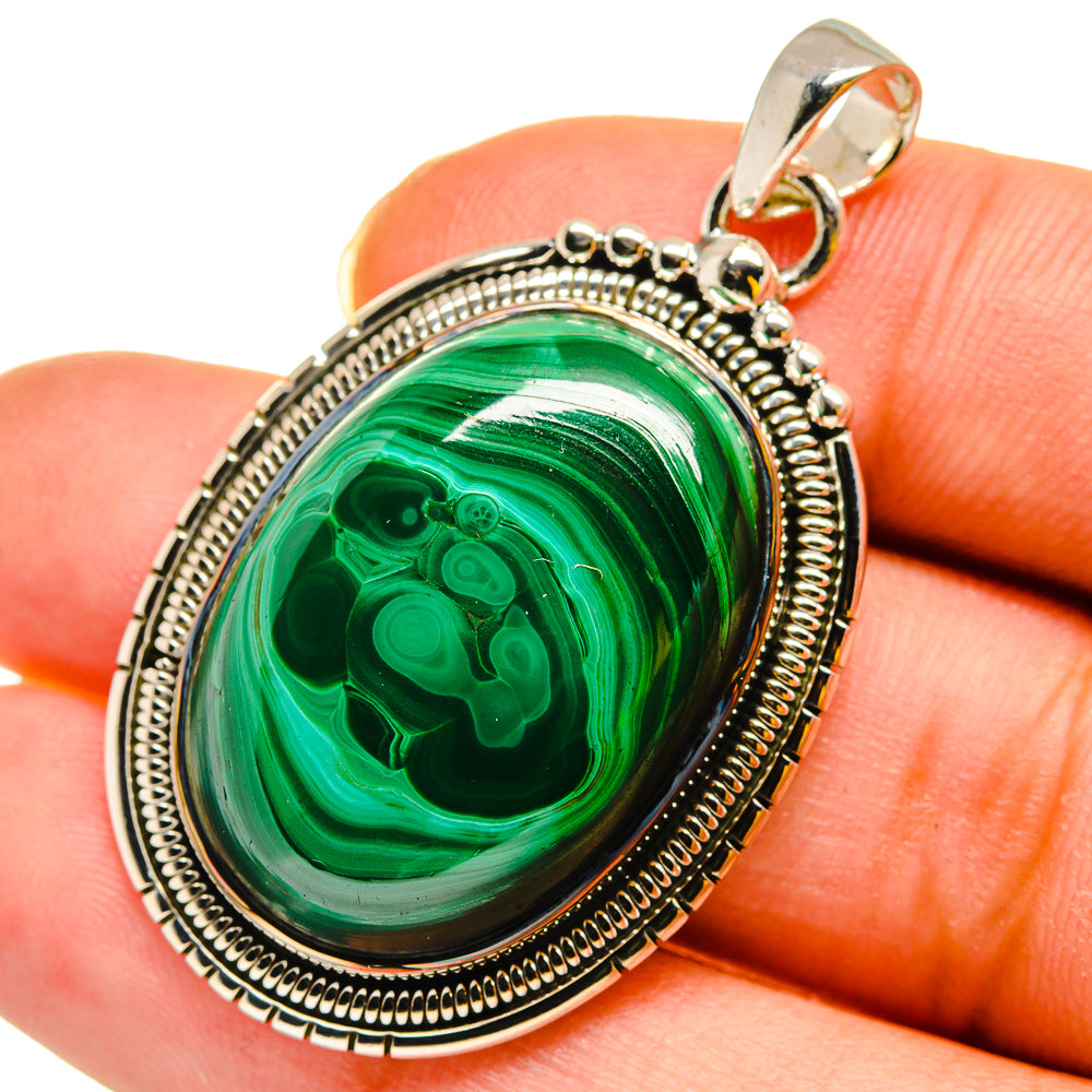 Oval green malachite cabochon pendant in sterling silver bezel with bail