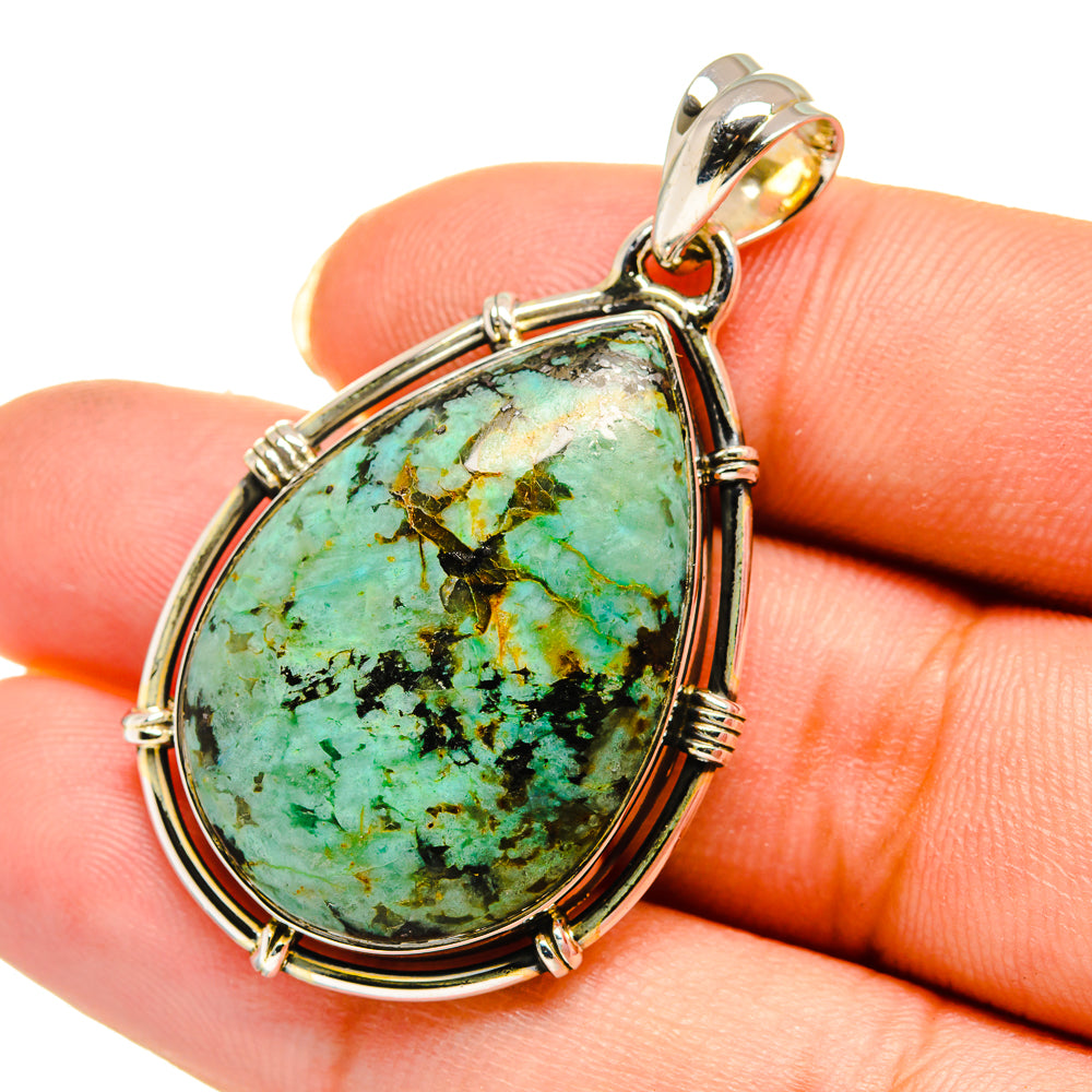 Turquoise teardrop pendant with visible stone matrix and sterling silver bail