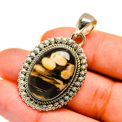 Oval peanut wood jasper pendant with ornate silver bezel and top loop bail