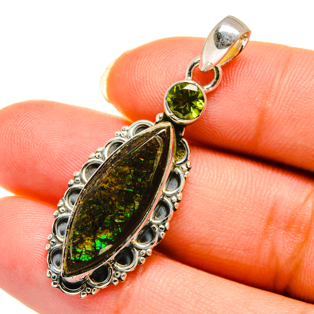 Close-up sterling silver pendant with round peridot and green iridescent ammolite