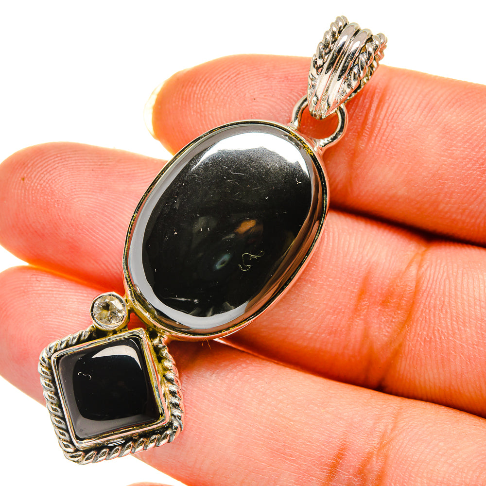 Sterling silver pendant with black oval and black square gemstones