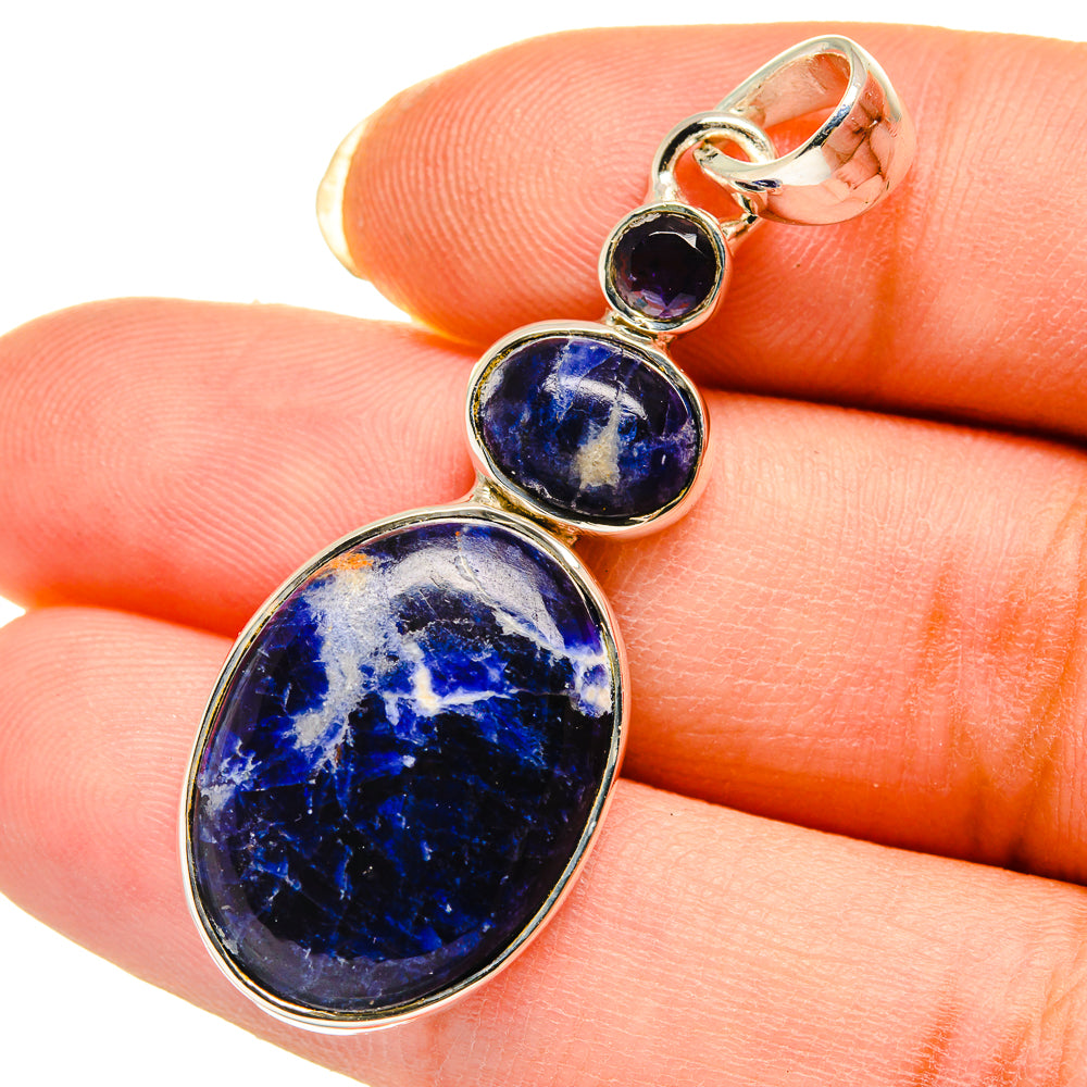 Oval sodalite pendant with purple stone accents in silver-tone bezel; close view