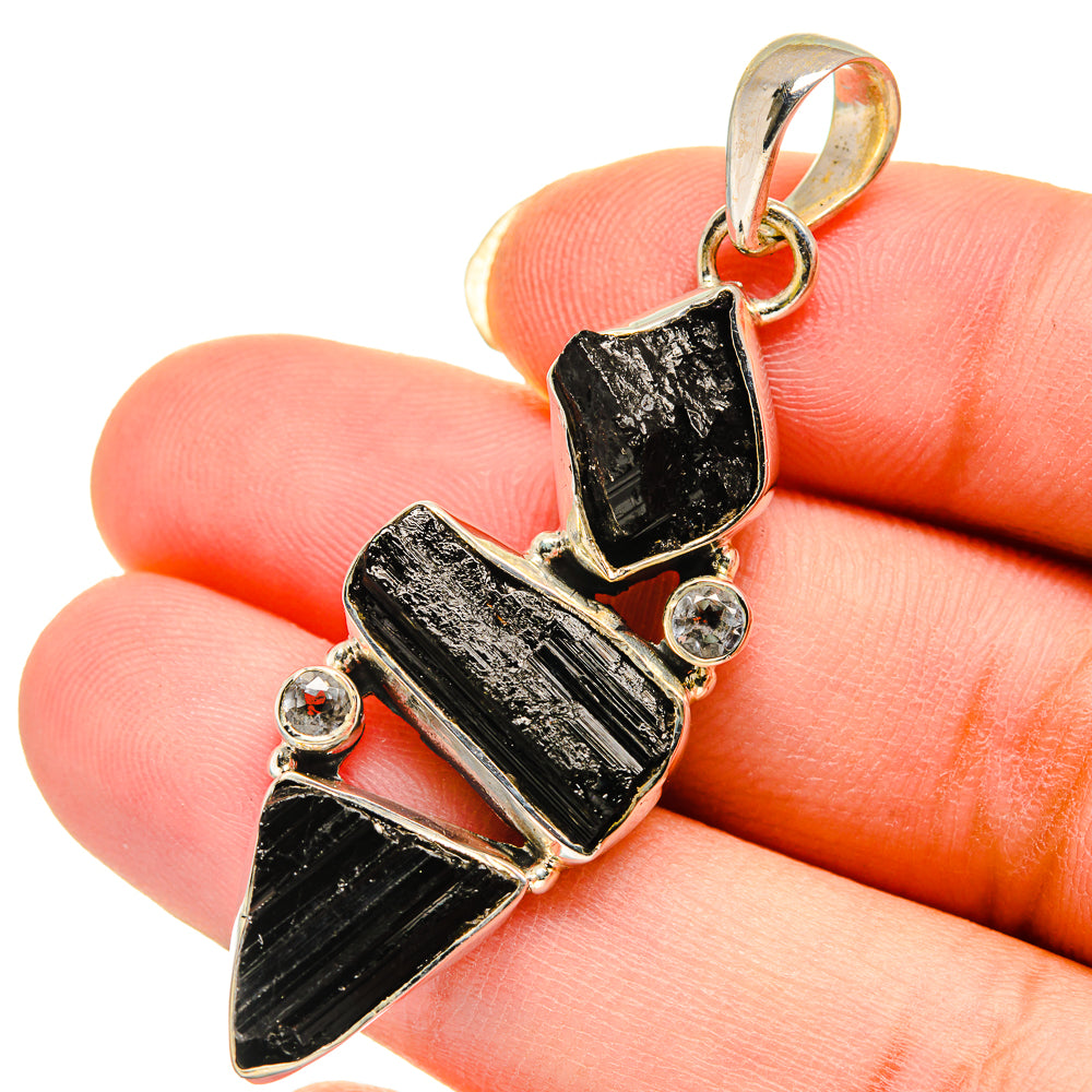 Rough black tourmaline pendant with white quartz accents, sterling silver bail